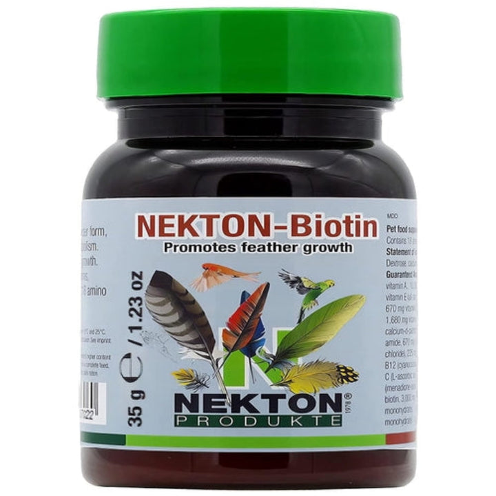 A bottle of Nekton Biotin pet supplement with a bright green cap and a white label featuring colorful feather illustrations and the Nekton Produkte brand name.