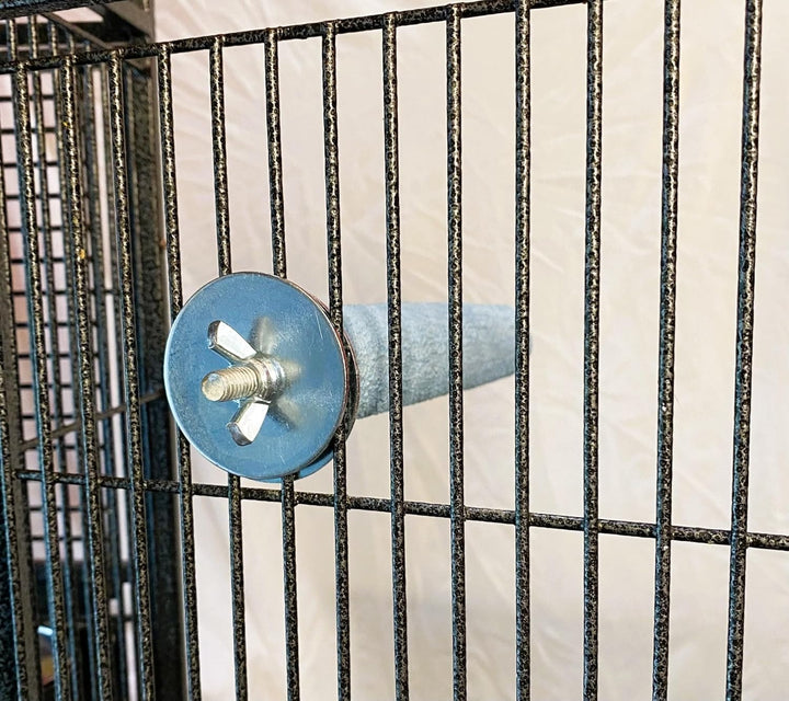 Metal screw against a black metal grid background