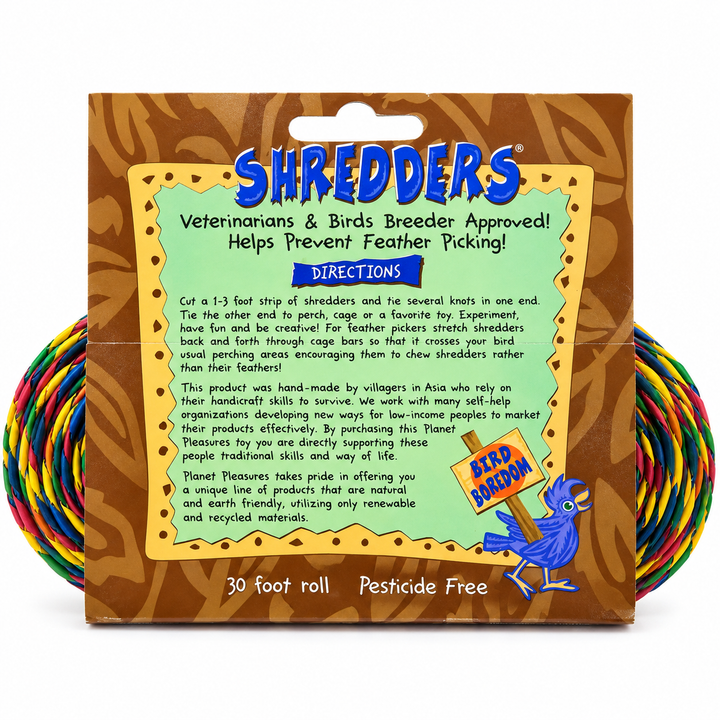 A packaged toy product labeled 'SHREDDERS' with a brown and tan camouflage-style outer card, a light green central label, and cartoon feather-picking game instructions plus a blue bird character holding a sign. The package text includes 'Veterinarians & Birds Breeder Approved,' 'Helps Prevent Feather Picking!,' '30 foot roll,' and 'Pesticide Free - Planet Pleasures Straight Rainbow Shredders - Small