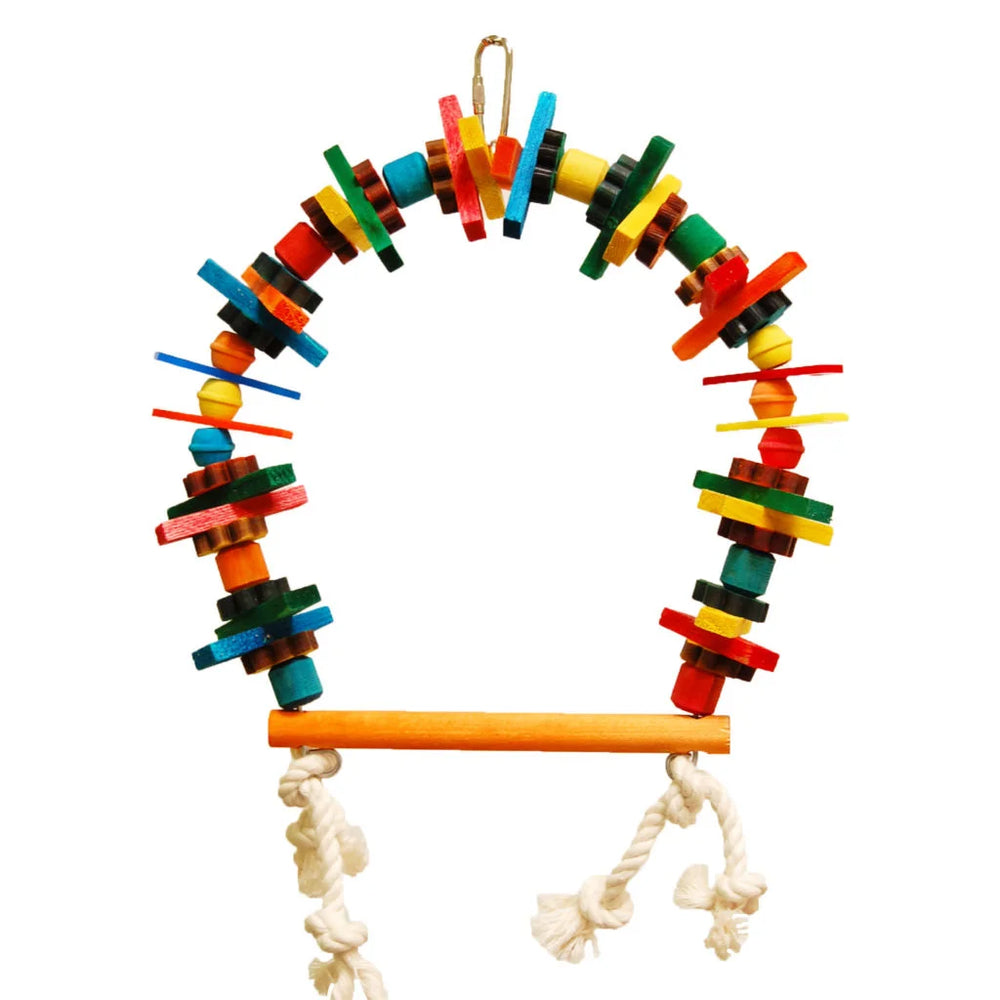 A colorful wooden bird toy with a hanging loop at the top, a curved arch made of stacked wooden blocks in multiple bright colors, and a horizontal wooden perch with white rope ties at the bottom, shown on a plain white background - Zoo-Max Block Bird Perch 6"